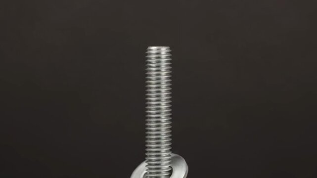 Video Effect Metal Washer Sliding Down a Threaded Rod