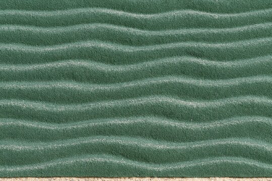 Green textured surface with wavy lines