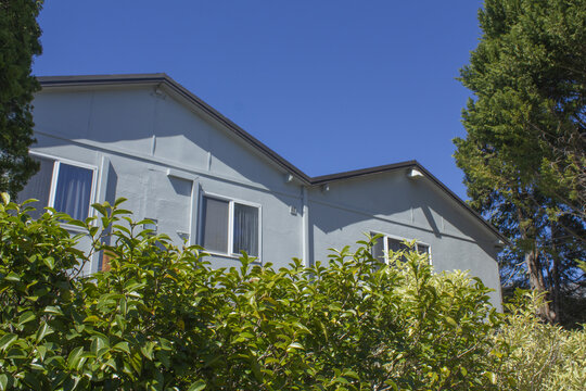 They are buildings with triangular roofs and trees.