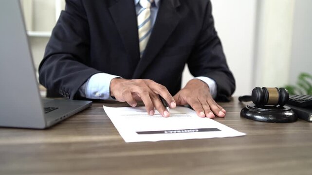 Lawyer reviewing legal documents and contracts, consulting clients on justice, legislation, court proceedings, government decisions, agreements, finance, and 