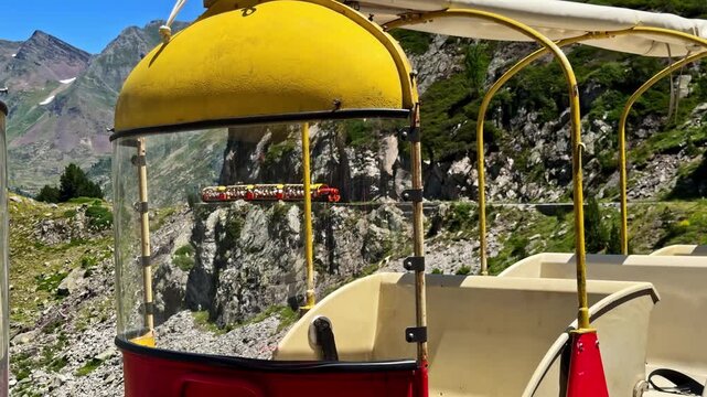 People riding the picturesque tourist Artouste train in the french Pyrenees mountains