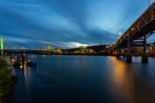 Marquam Bridge and Tilikum Crossing Bridge over Willamette River in Portland, Oregon, in twilight
