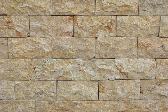 Textured natural sandstone brick wall background texture