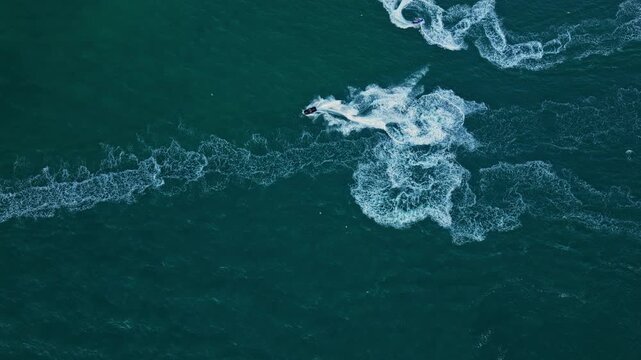 Sea beach lifestyle. Beach life concept. Vacation on summer. Aerial view at vacation. Jet ski in motion footage. Summer vacation activity. Water sport activity in summer
