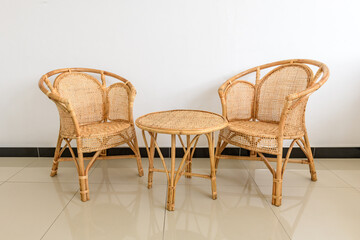 Fototapeta premium Rattan chairs and a round coffee table in a modern living room