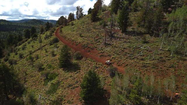 Aerial Drone View of UTV Off-Road Vehicles Driving up Mountain Trail Utah