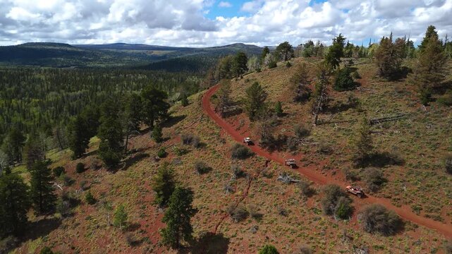 Aerial Drone View of UTV Off-Road Vehicles Driving up Mountain Trail Utah