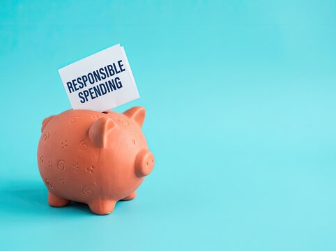 Terracotta piggy bank with responsible spending note suitable for financial planning campaigns representing wise budget control and saving goals
