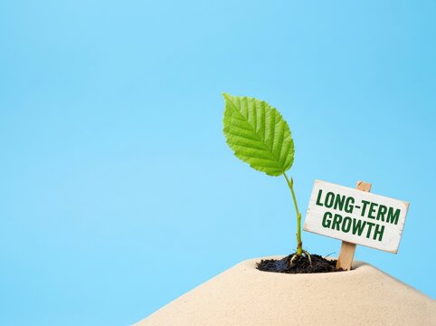 Green plant sprout on sand with a long term growth sign ideal for business strategy media symbolizing sustainable investment and future success