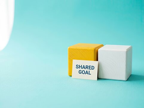 Yellow and white blocks with shared goal text suitable for teamwork and strategy content symbolizing unity collaboration and mutual target