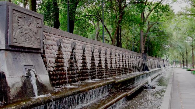 Amazing ancient aztec fountain Chapultepec park nezahualcoyotl Mexico City green trees water running stone sacred