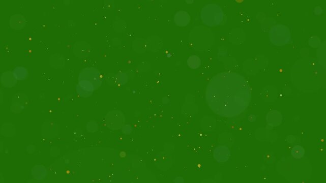Golden glitter dust particles and soft bokeh circles floating on green screen background, 4K sparkling magic dust overlay animation for chroma key compositing, festive holiday and fantasy video effect