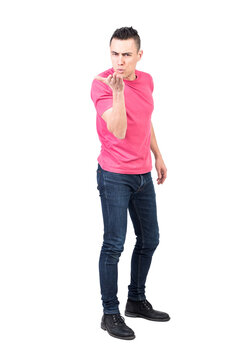 Full body of romantic male in casual clothes sending air kiss to camera while looking at camera