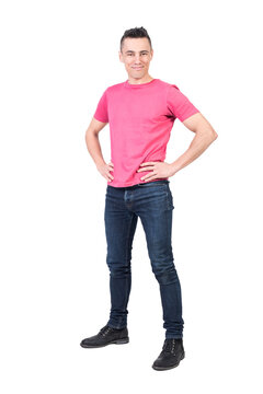 Full body of positive male model in casual outfit looking at camera with smile while standing with hands on waist