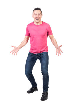 Full body of positive male in casual clothes looking at camera with astonished face expression
