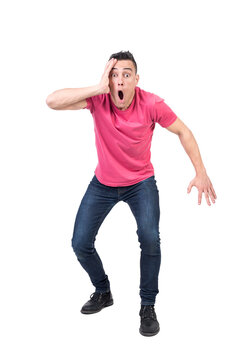 Full body of amazed male touching face and looking at camera with opened mouth