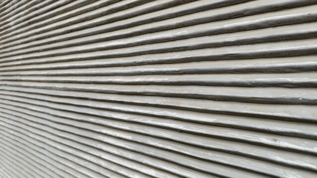 a close-up, perspective shot of a textured surface with uniform, horizontal ridges. he parallel lines run across the frame, creating a strong sense of depth and linear patterns