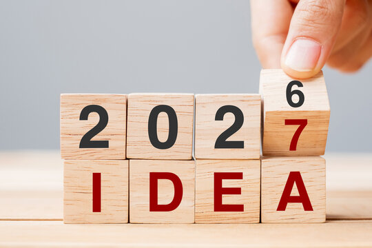 hand flipping block 2026 to 2027 IDEA text on table. goal, Resolution, strategy, plan, motivation, reboot, business and New Year holiday concepts