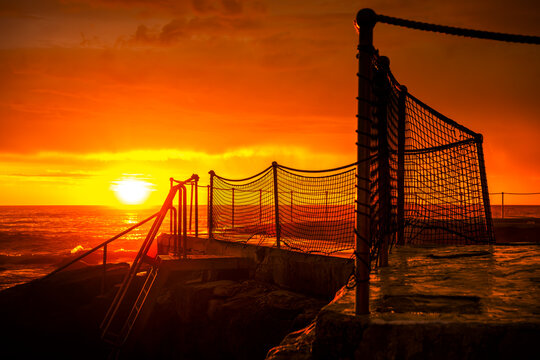 Sunrise over Bronte Ocean Pool and the Pacific Ocean at Bronte Beach in Sydney, New South Wales, Australia.