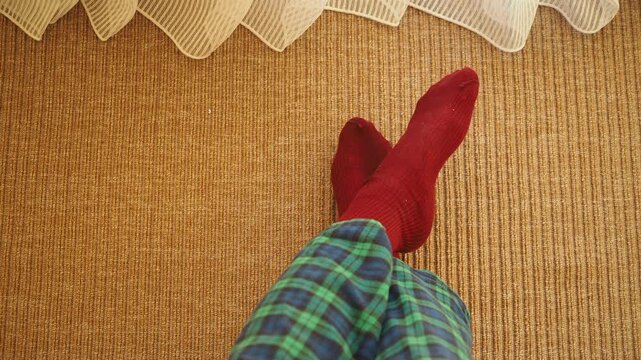Relaxing at home with red socks and plaid pajamas on a sunny day