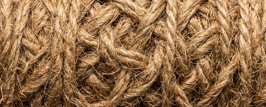 Macro close up of brown jute twine rope texture with natural fibers for rustic background design