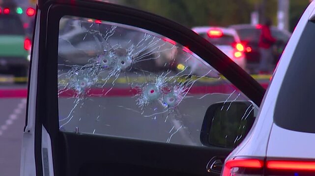 DRIVER SIDE WINDOW SHOT UP WITH BULLET HOLES IN GANG SHOOTING