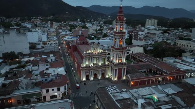 Panoramic view of illuminated colonial church and city buildings in Salta, Argentina at sunset