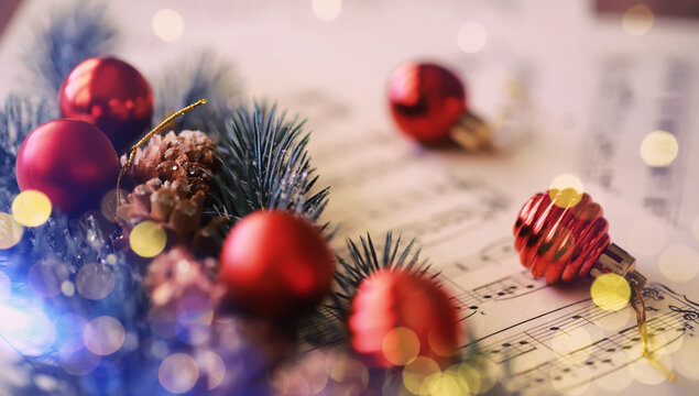 Christmas decorations and fir branch lying on notes sheet