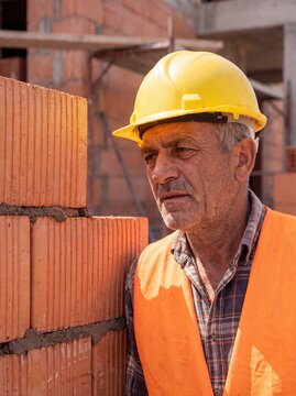 professional worker using masonry trowel and cement mortar during construction