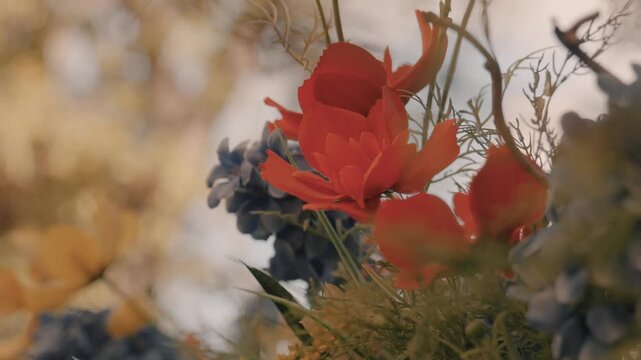 Red decorative flowers for decorating outdoor cafes, store entrances, and counters. Decorating public spaces.