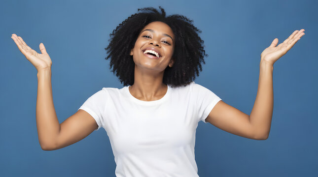 Joyful African American woman with arms raised in excitement.