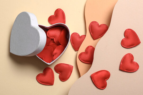 Red hearts with box on a wavy layered background. Creative layout. Love concept