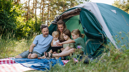 Obraz premium Happy family spending time together during summer camping trip.