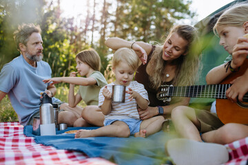 Obraz premium Happy family spending time together during summer camping trip.