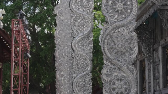 Silver embossed vine pattern on temple columns