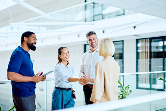 Diverse business professionals having a meeting, shaking hands and collaborating, creating new connections in a contemporary corporate environment
