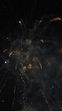Golden fireworks exploding in dark night sky during festive celebration and holiday event