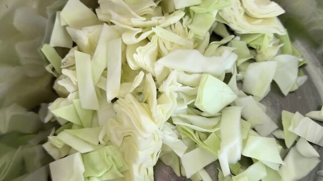 Chopped Cabbage Filling a Glass Mixing Bowl