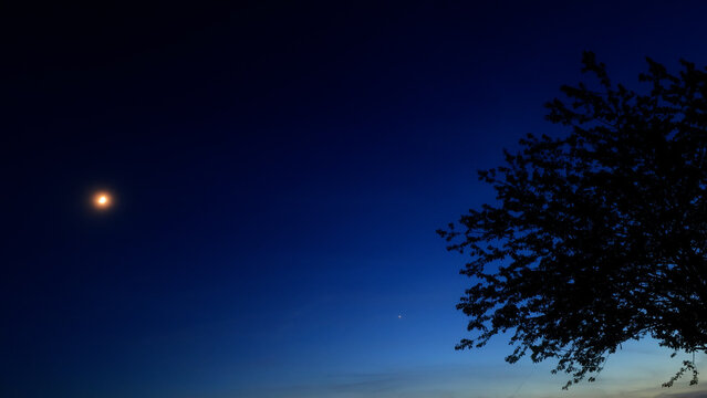 Moon, planet conjunction and landscape scenery silhouettes.