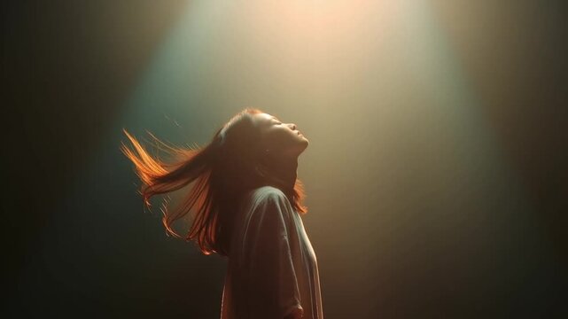 A young woman tilting her head back with her eyes closed, bathed in a dramatic spotlight, her hair flying with the motion. ..Created with Generative AI, not depicting real subjects.