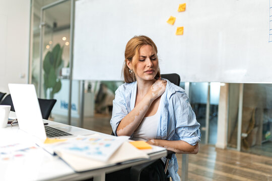 Pain in the shoulder. Upper arm pain, People with body-muscles problem, Healthcare And Medicine concept. Attractive woman sitting on the chair and holding painful shoulder with another hand.