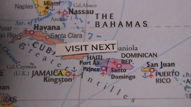 Travel planning concept with Visit Next tag placed over Caribbean map
