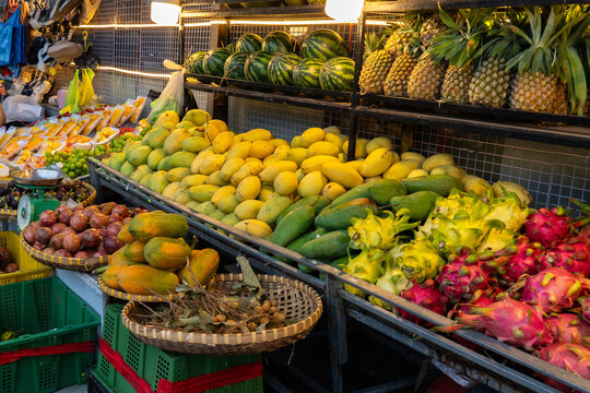 A Vibrant Display of Fresh Fruits in a Colorful Market Setting Showcasing a Variety of Tropical Produce and Baskets Overflowing with Natural Delights