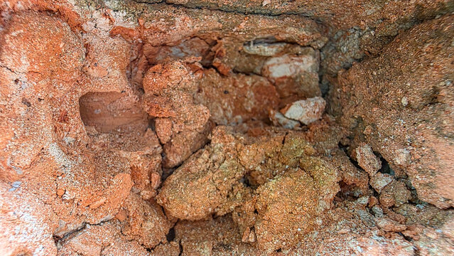 Detailed Close-up Texture of Natural Red Clay Soil and Earth Layers in a Geological Formation