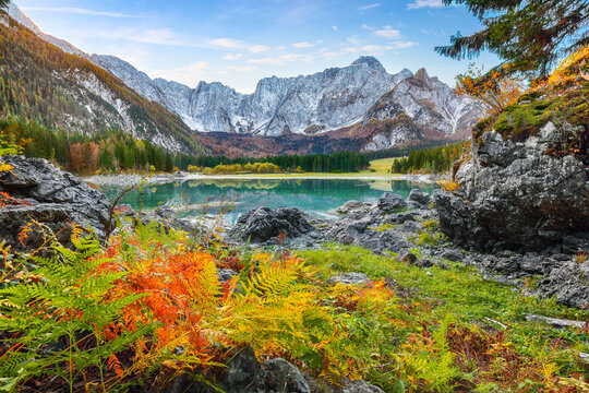 Breathtaking view of Fusine lake with Mangart peak on background.