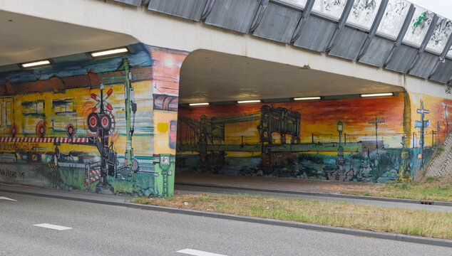 Zwolle, Netherlands - 23 August 2026 - Vibrant street art mural depicting train and bridge motifs inside concrete underpass tunnel.