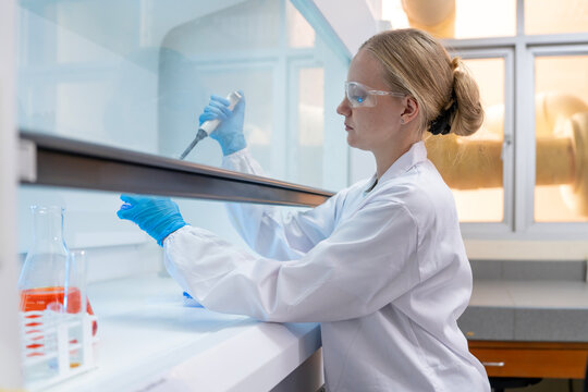 Medical Research Laboratory Portrait of a Beautiful Female Scientist in Goggles Using Micro Pipette for Test Analysis. Advanced Scientific Lab for Medicine, Biotechnology, Microbiology Development
