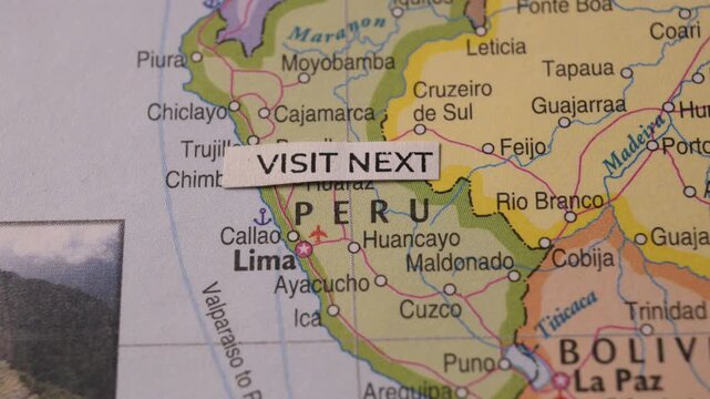 Hand Placing Visit Next Text Label on Peru Map