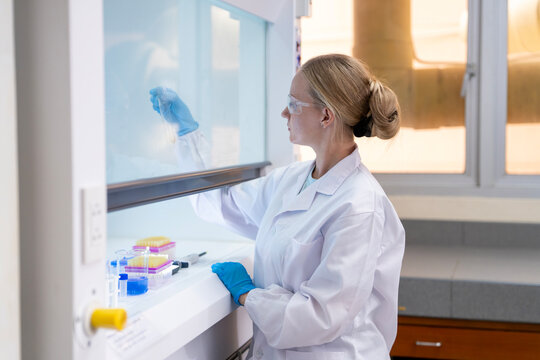 Medical Research Laboratory Portrait of a Beautiful Female Scientist in Goggles Using Micro Pipette for Test Analysis. Advanced Scientific Lab for Medicine, Biotechnology, Microbiology Development