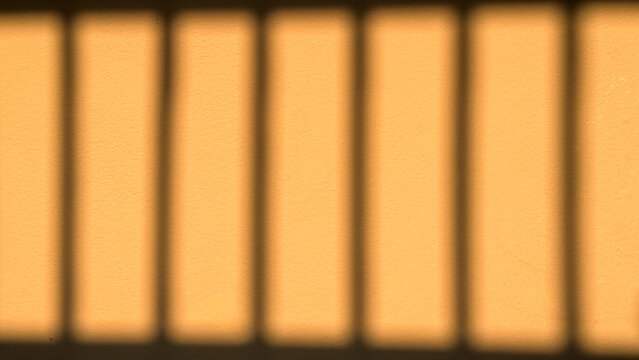 Minimalist shadow play background with vertical window light bars and warm textured wall